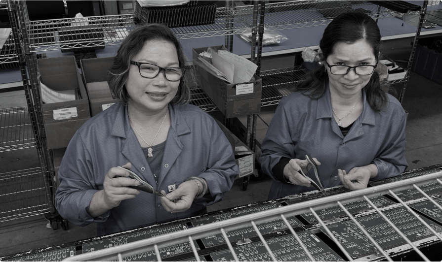 image of 2 printed circuit board assemblers in industrial setting